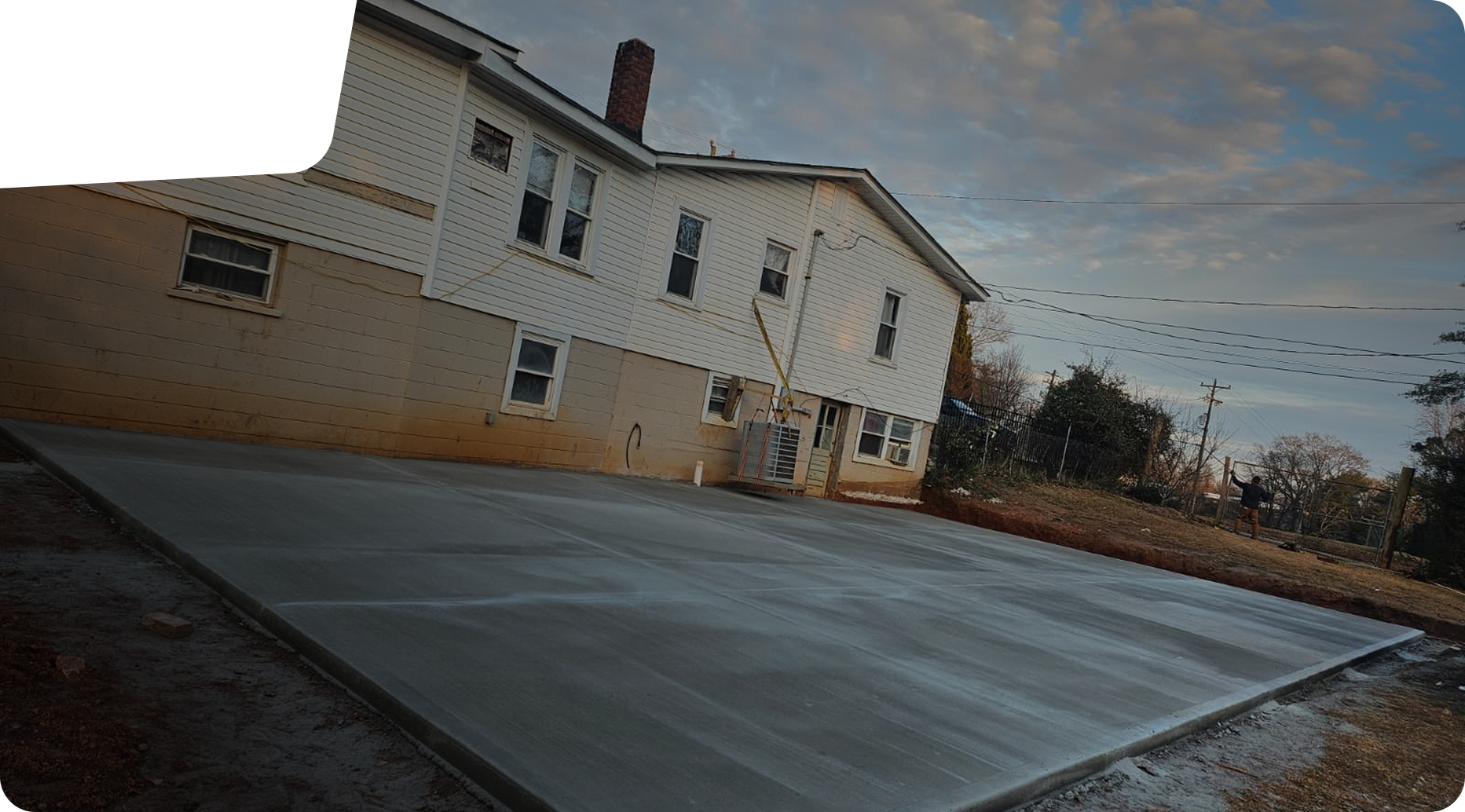 Freshly poured concrete slab in front of a residential property